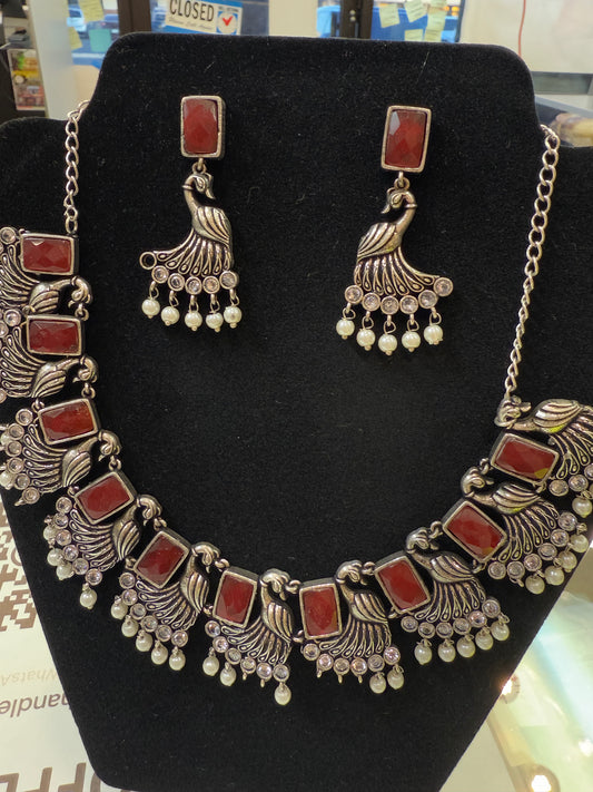 Amazing Maroon Stone Studded German Silver Plated Peacock Design Oxidized Necklace Set With Earrings And Pearl Beads