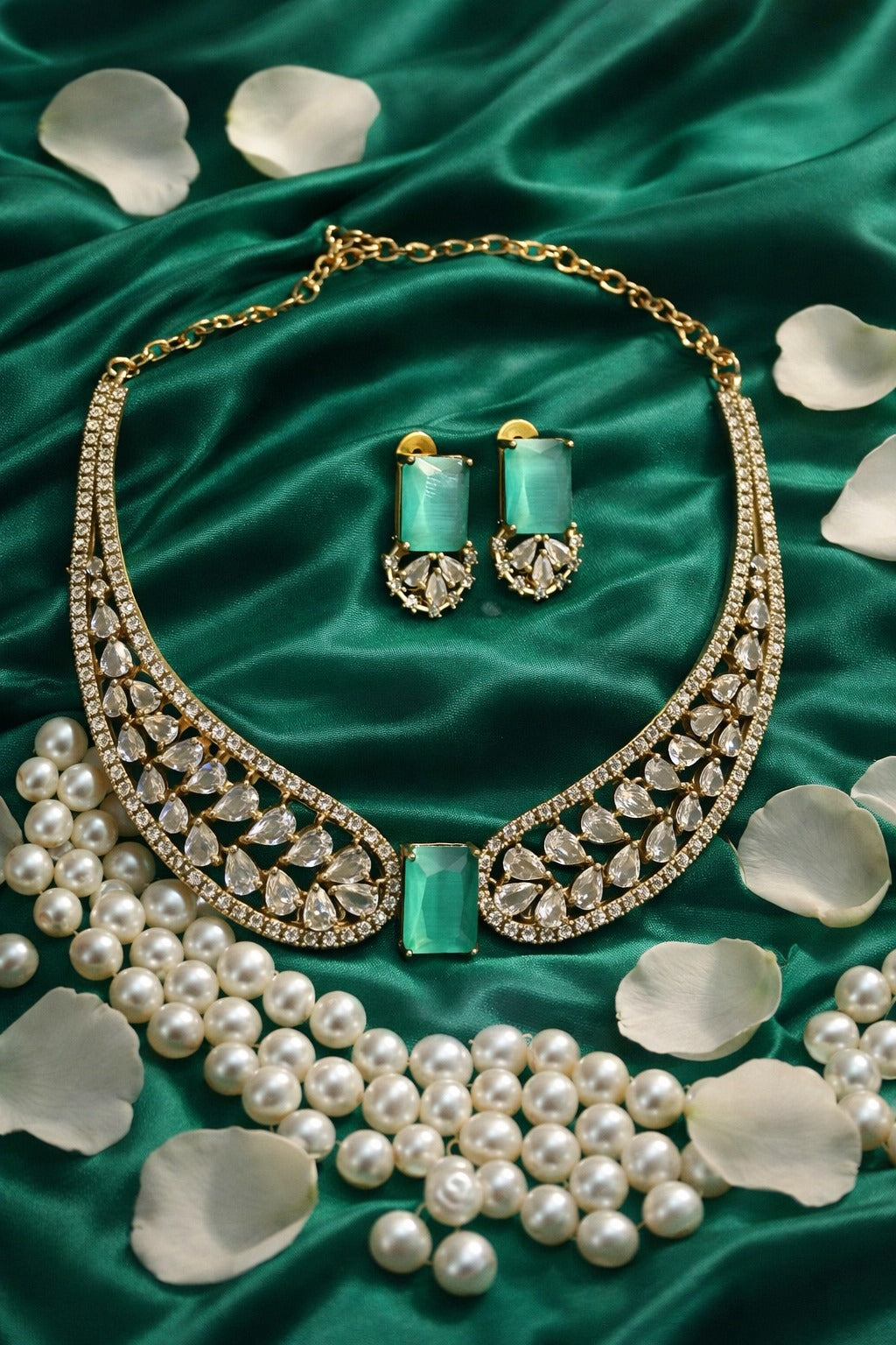 Gorgeous fancy gold plated necklace set with green and white stones.