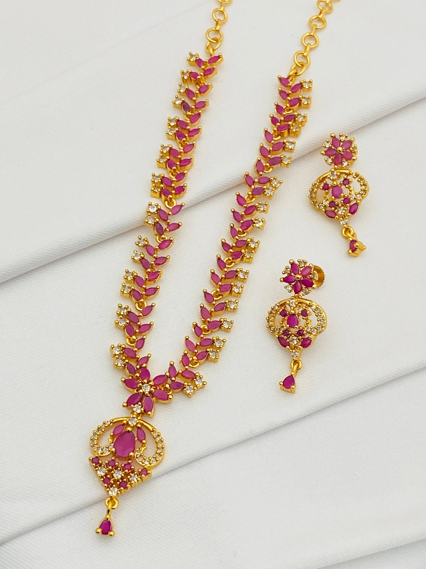 Delightful Ruby Stoned Traditional Wear Gold Plated Necklace With Earrings