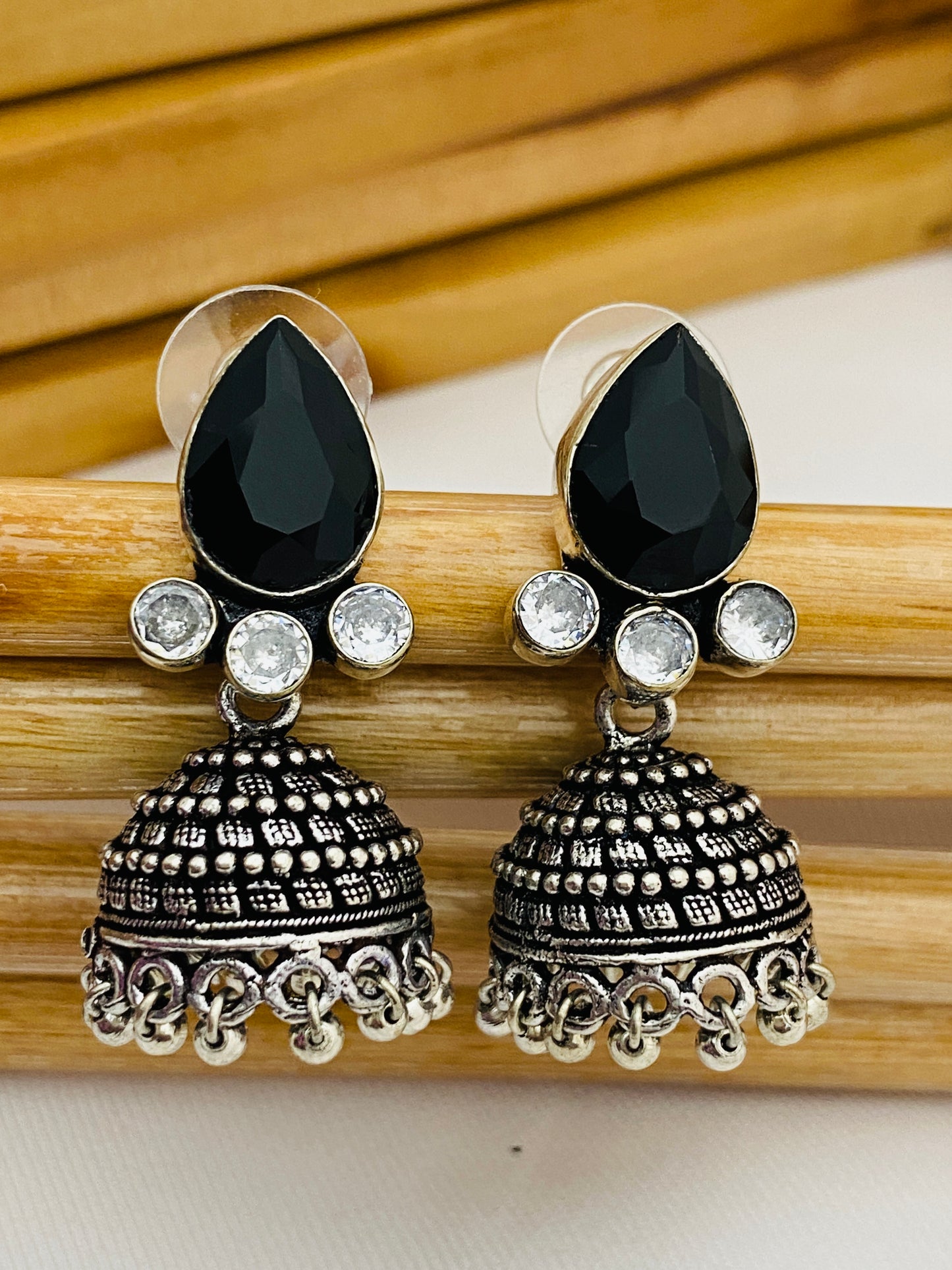 Elegant Black AD Stone Beaded German Silver Plated Jhumka Earrings With Black Pearl Drops