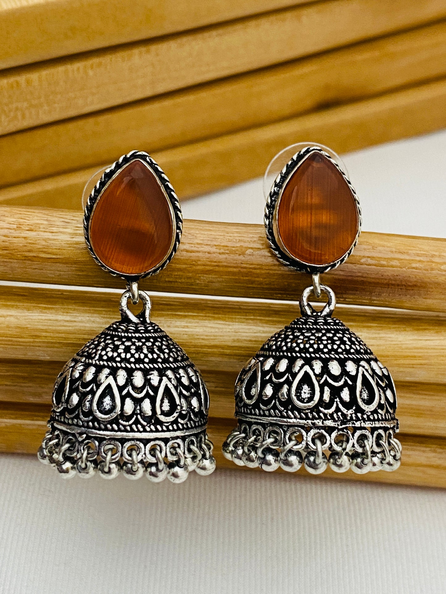 Two Tone Orange Stone Beaded Silver Toned Designer Oxidized Jhumkas in Yuma