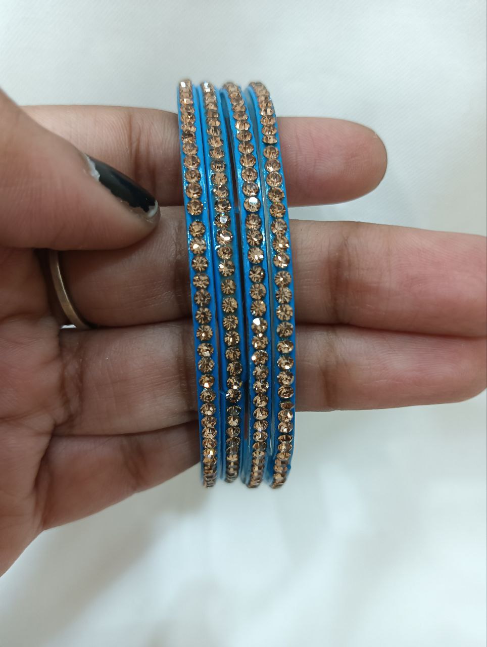 Pleasing Blue Color Glass Bangles With Flashing Gold Stone Near Me