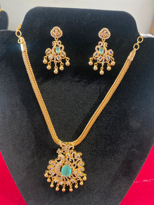 Amazing Teal Green And White Color Stone Peacock Locket Gold Plated Necklace Set With Earrings