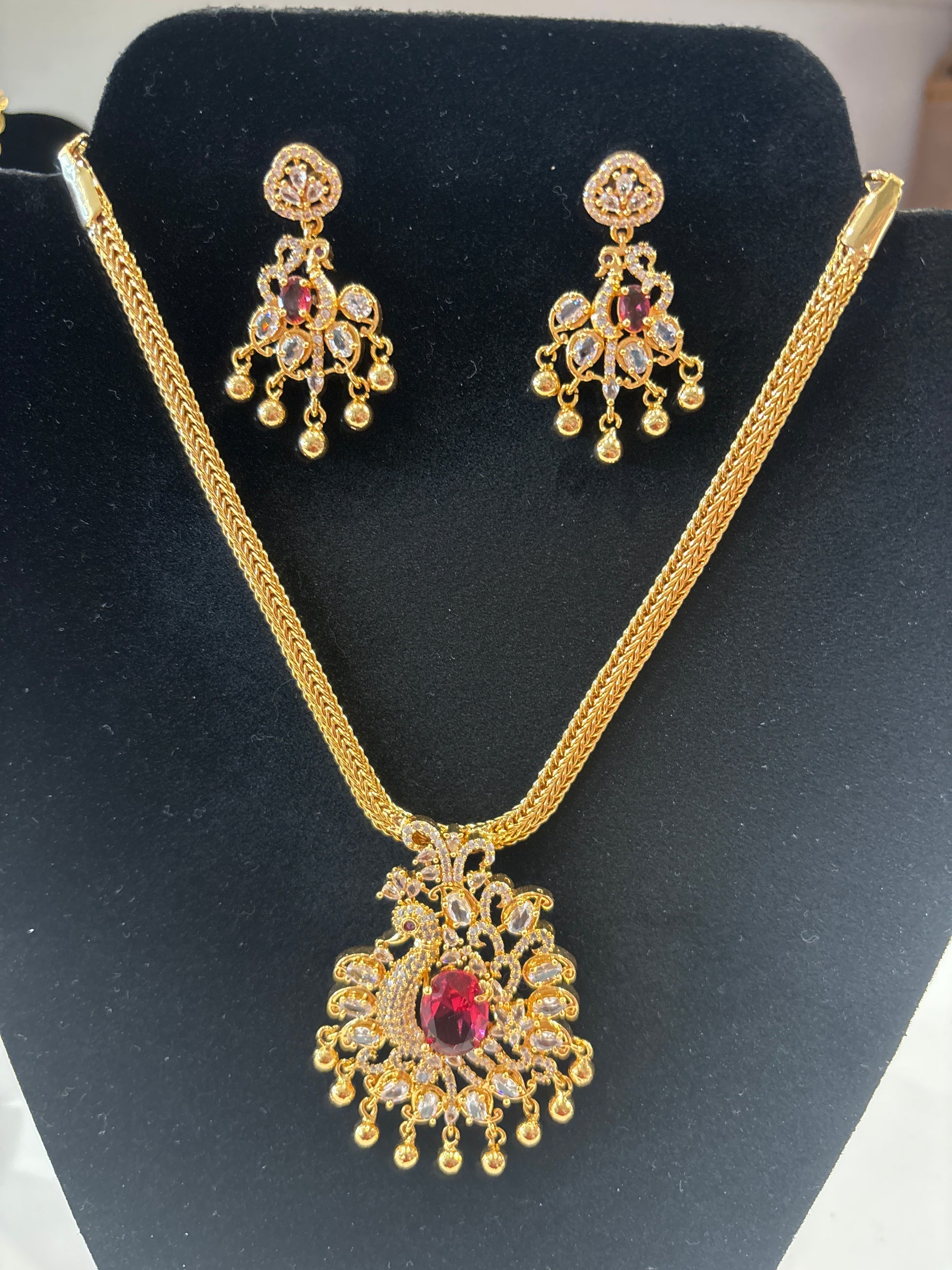 Amazing Red And White Color Stone Peacock Locket Gold Plated Necklace Set With Matching Earrings For Women