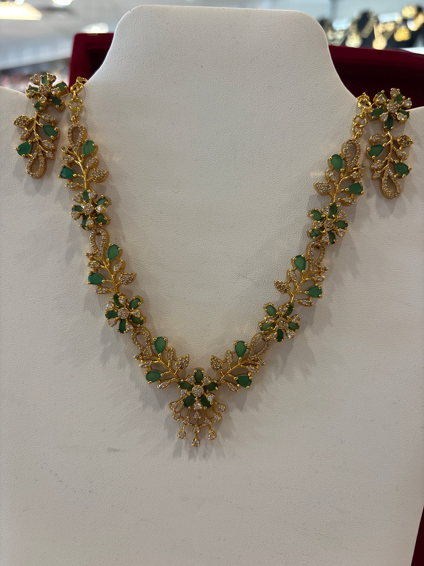 Dazzling Green And White Stones Floral Design Gold Plated Necklace With Earrings Set