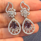Dazzling White and Purple Stones Gold American Diamond Earrings