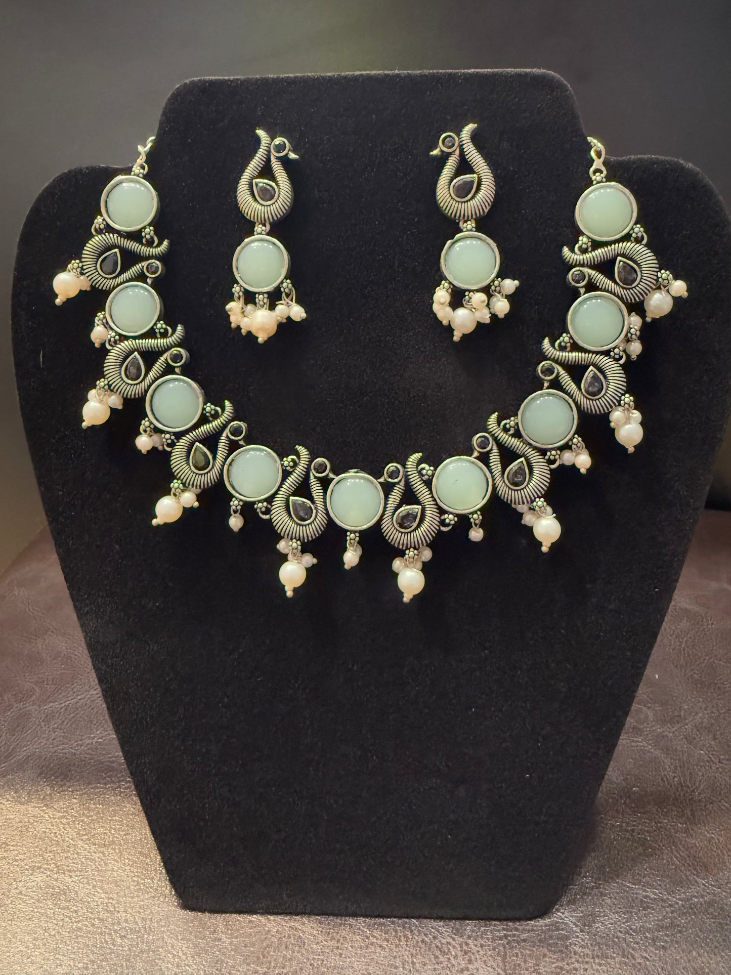 Amazing Sky Blue Stone Studded Peacock Design Silver Plated Oxidized Necklace Set With Earrings And Pearl Beads