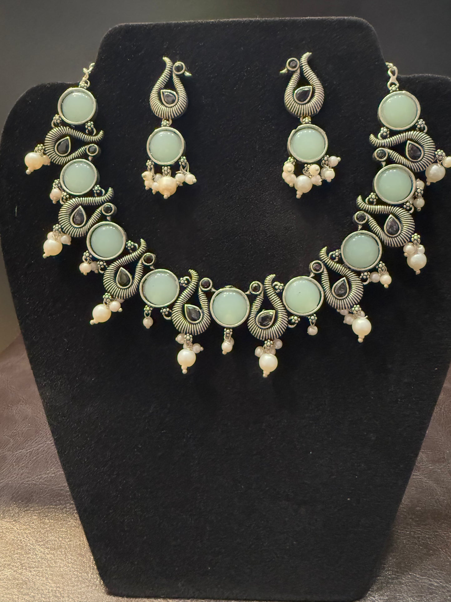 Amazing Sky Blue Stone Studded Peacock Design Silver Plated Oxidized Necklace Set With Earrings And Pearl Beads