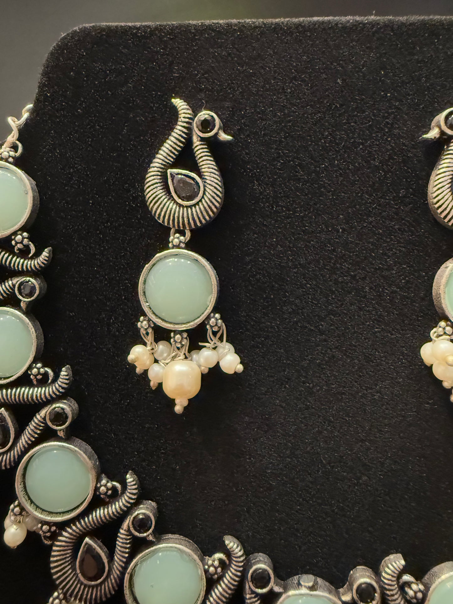 Amazing Sky Blue Stone Studded Peacock Design Silver Plated Oxidized Necklace Set With Earrings And Pearl Beads