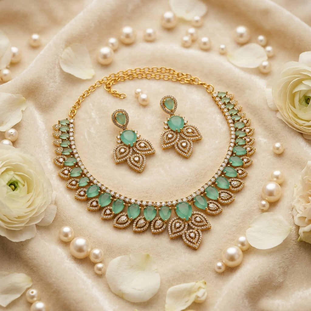 Stunning leaf shaped with light green kundan and white stones gold plated jewelry set.