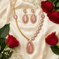 Fancy pink kundan and white stones gold plated jewelry set.