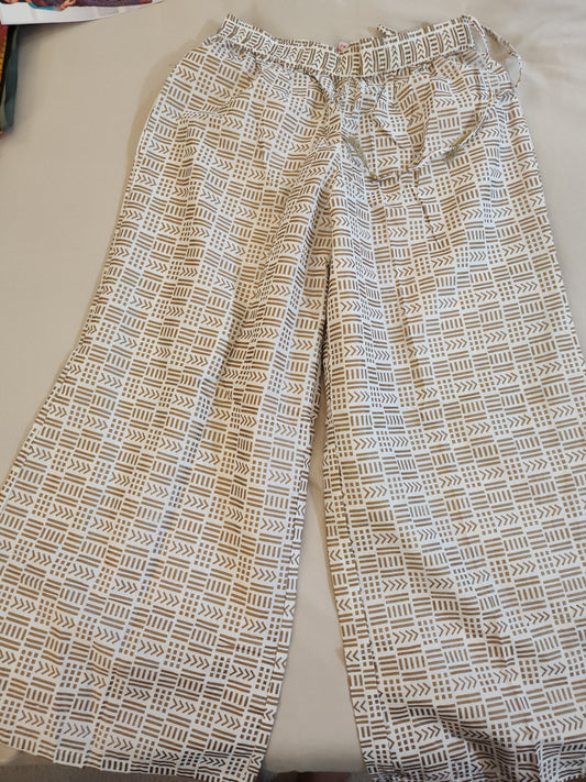 Alluring White Colored Palazzo Pants With Gold Print For Women