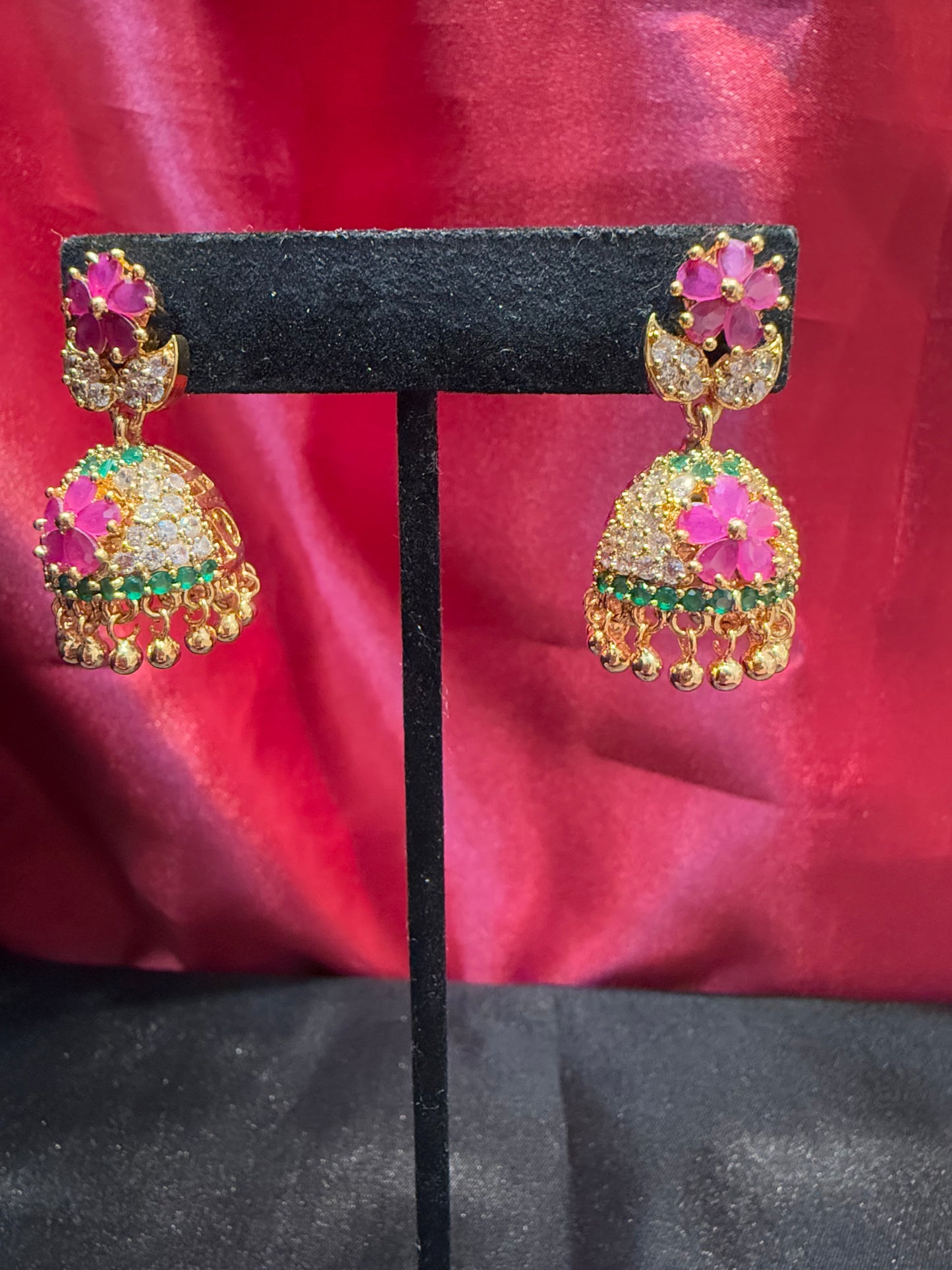 Dazzling Gold Plated Designer Jhumka with Hot Pink Color Stone And Golden Beads With Flower Designs