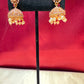 Alluring Gold Plated Designer Jhumka With White Color Stone  And Beaded Design