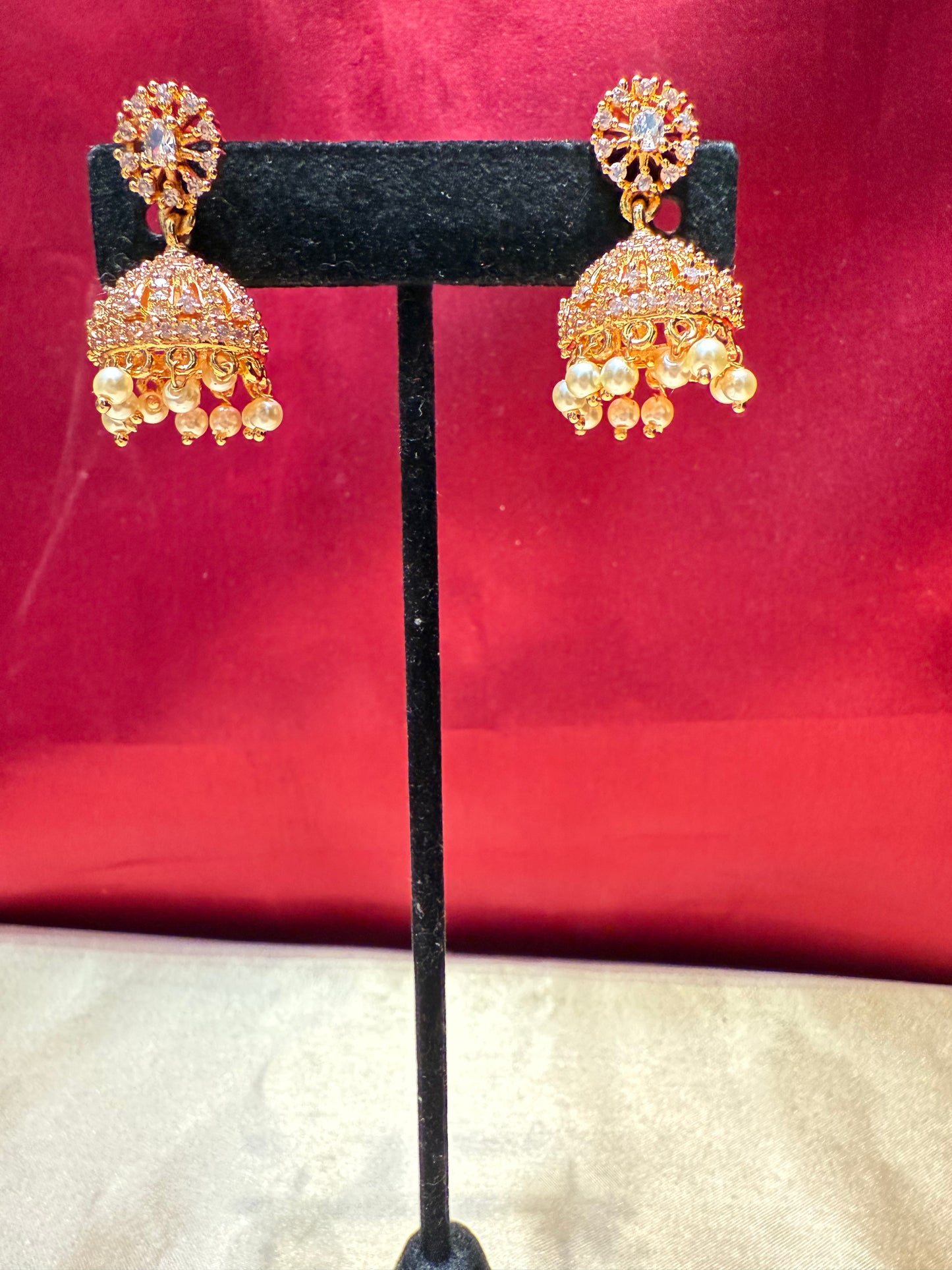 Alluring Gold Plated Designer Jhumka With White Color Stone  And Beaded Design