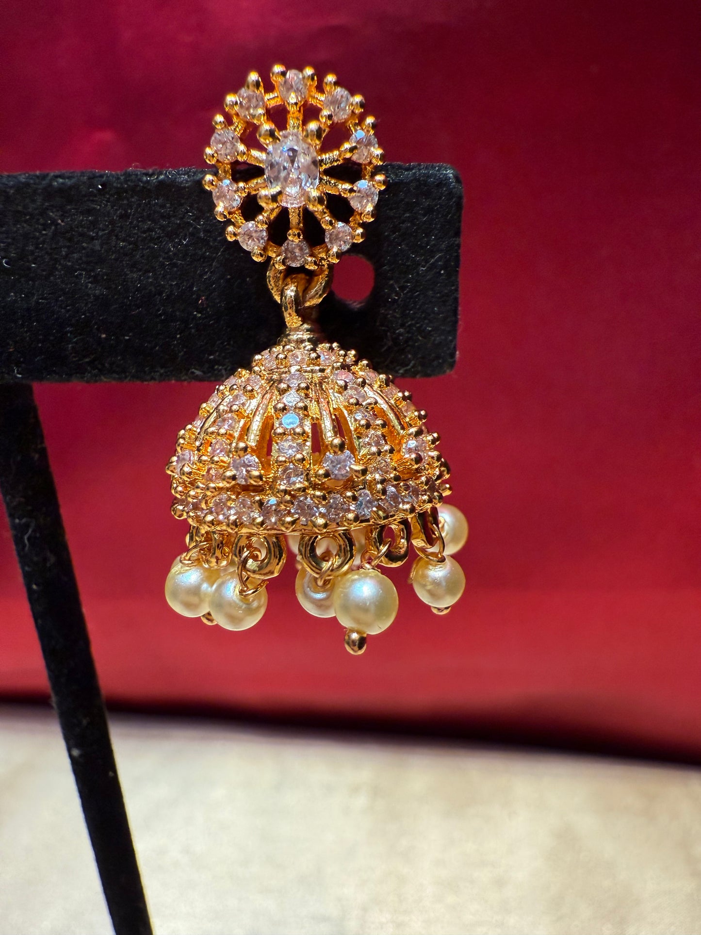 Alluring Gold Plated Designer Jhumka With White Color Stone  And Beaded Design