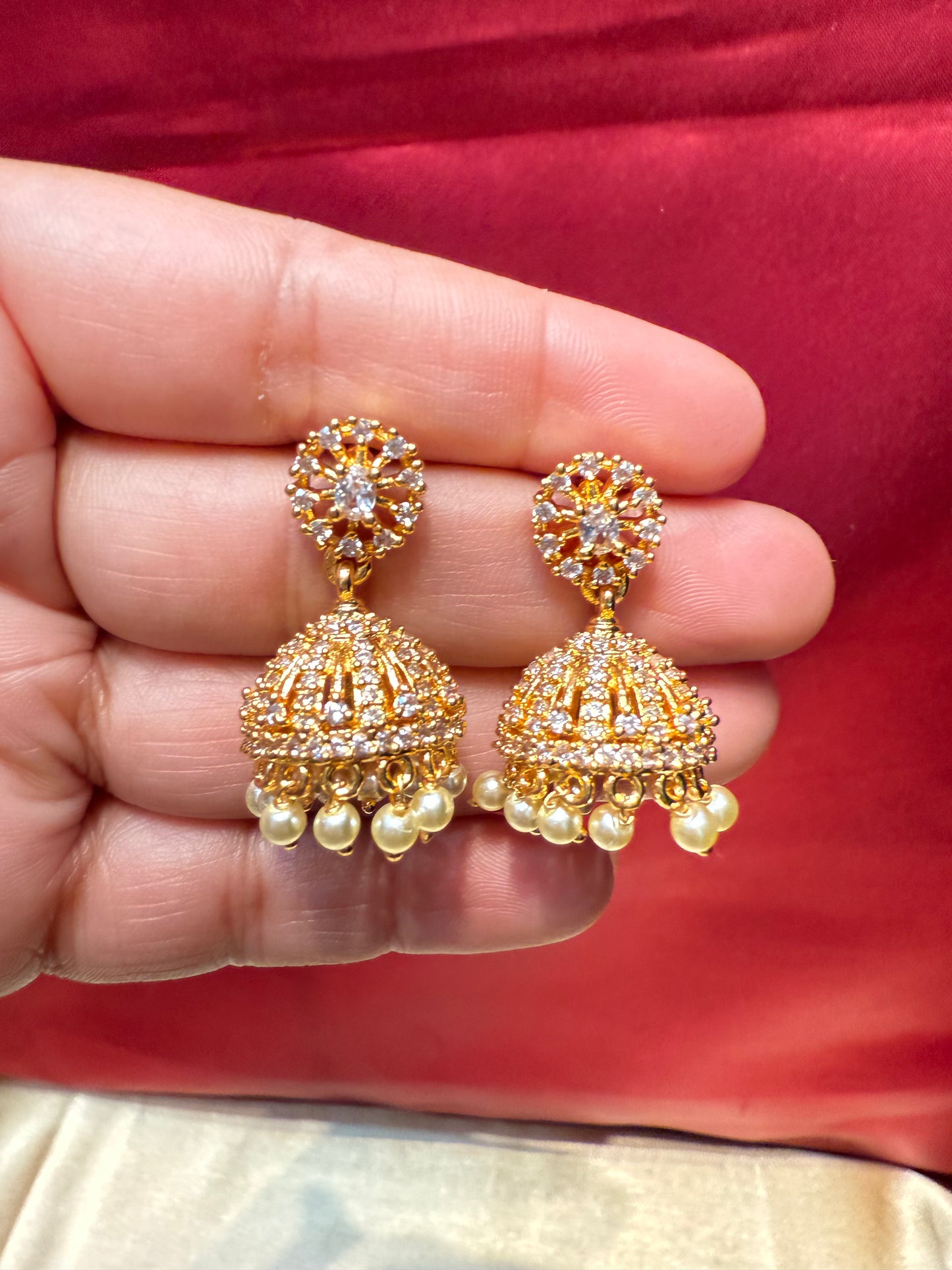 Alluring Gold Plated Designer Jhumka With White Color Stone  And Beaded Design