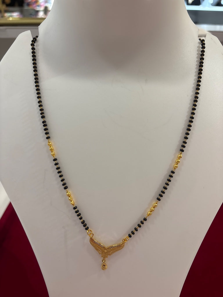 Modern Black Bead Long Chain Mangalsutra With Ornate Gold Pendant
