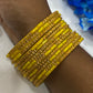 Appealing Yellow Color Stone Work Glass Bangles For women