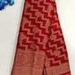 Attractive Red Color Georgette Designer Saree With Flower Motifs And Fancy Tassels