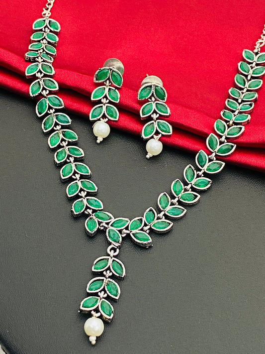 Alluring Emerald Stone Studded Leaf Shaped German Silver Plated Oxidized Necklace With Earrings