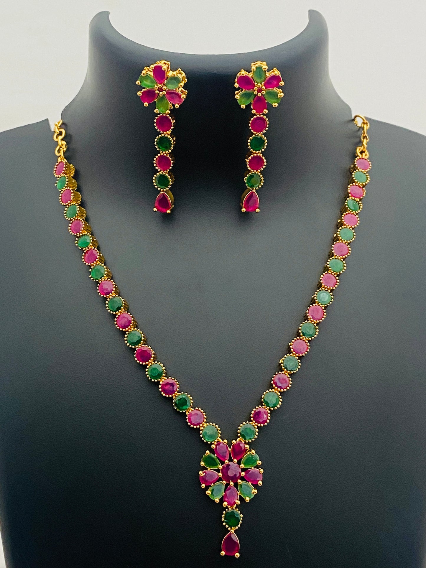 Traditional Gold Plated Emerald And Ruby Stone Studded Floral Shaped Necklace With Earrings