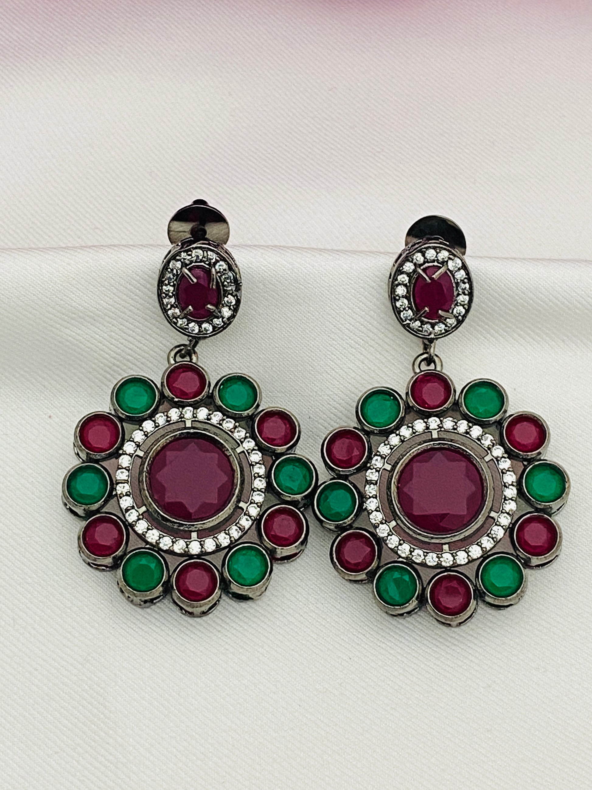 Ravishing Emerald And Ruby Stone Studded Floral Design German Silver Plated Dangle Earrings