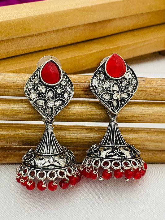 Alluring Red Stone Studded Floral Design German Silver Plated Oxidized Jhumka Earrings For Women