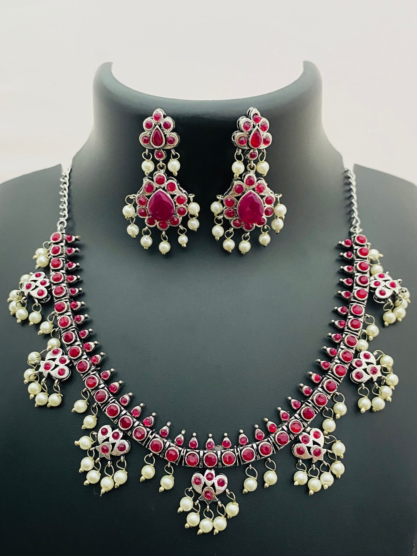 Alluring Ruby Stone Studded Flower Design Silver Toned Oxidized Necklace Set With Earrings