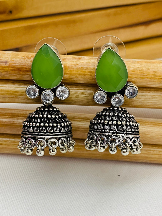 Lovely Green AD Stone Beaded Silver Toned Designer Jhumka Earrings With Black Pearl Drops