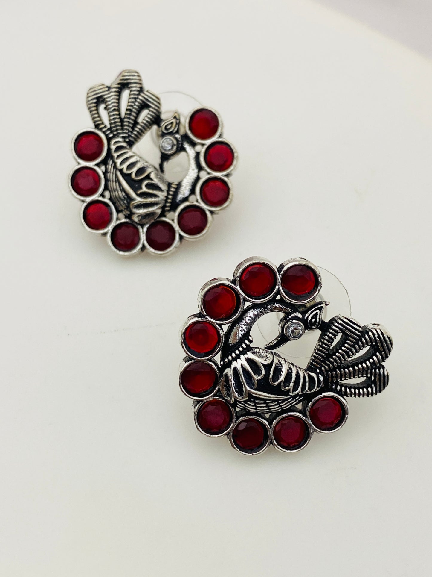Appealing Red Stone Studded Peacock Designed Silver Toned Oxidized Stud Earrings