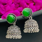 Elegant Emerald Stone Studded Silver Toned Oxidized Jhumka Earrings With Black Pearl Beads