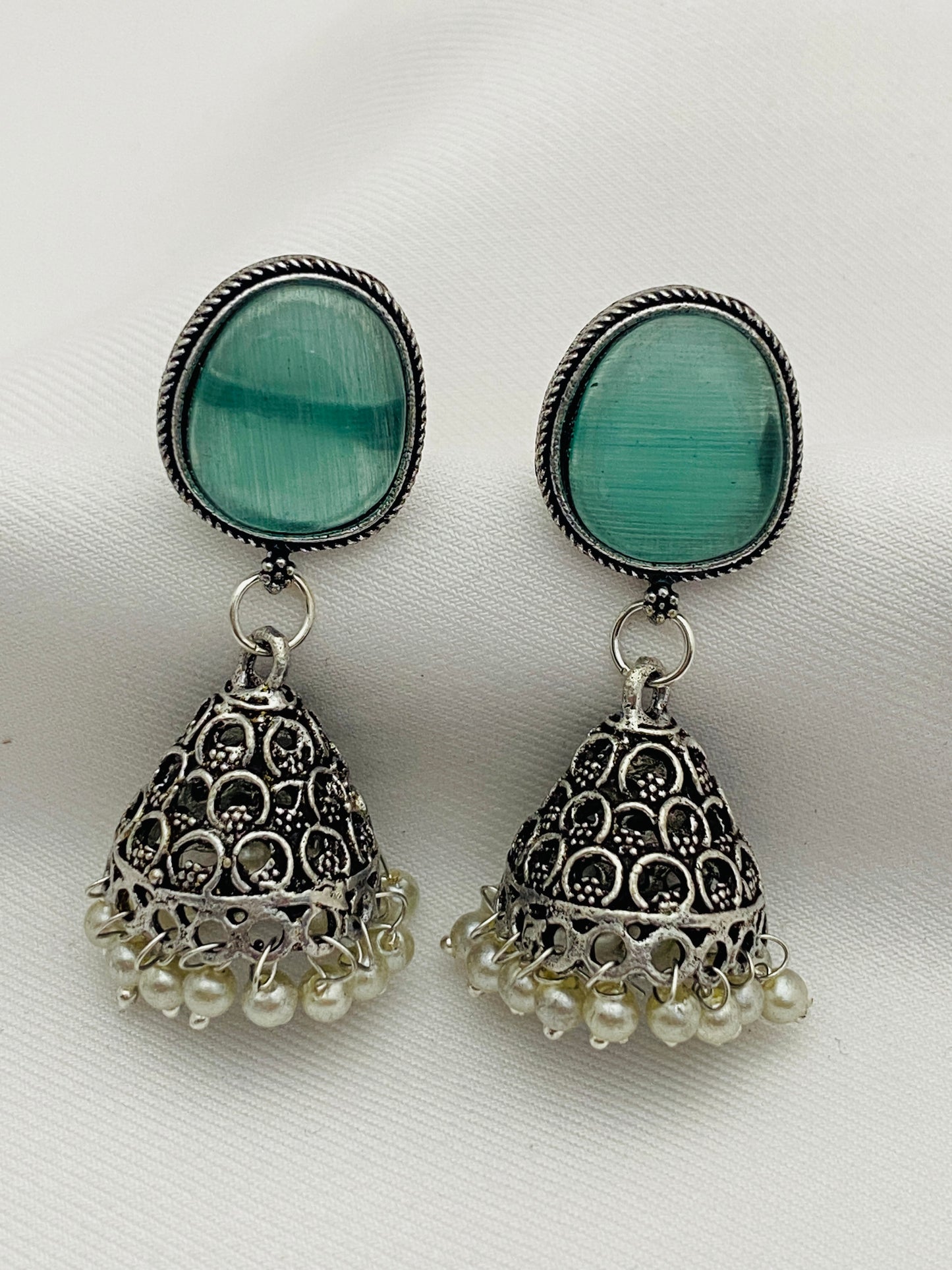 Unique Teal Blue Stone Studded Dome Shaped Silver Plated Oxidized Jhumka Earrings With Pearl Drops