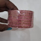 Alluring Dark Pink Color Glass Bangles With Glittering Stones For Women