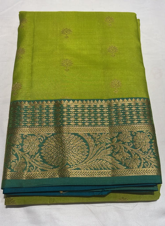 Attractive Olive Green Color Pure Kanchi Silk With Floral Butta Motifs And Teal Blue Color Border Golden Zari Work Saree For Women