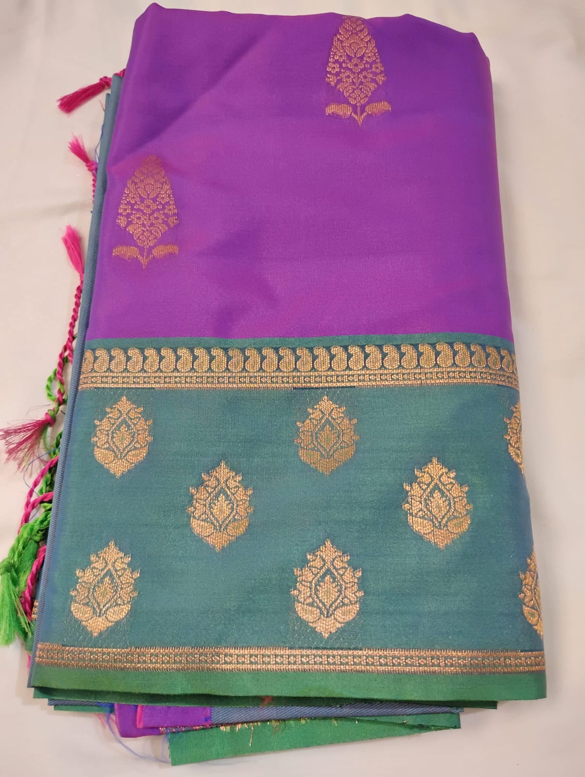 Premium Kanchi Silk Saree In Royal Purple Color And Teal Blue Featuring Intricate Gold Zari Motifs And A Classic Woven Border Saree For Women