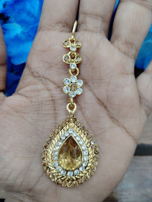 Alluring Beautiful gold color tikka with white and brown stones