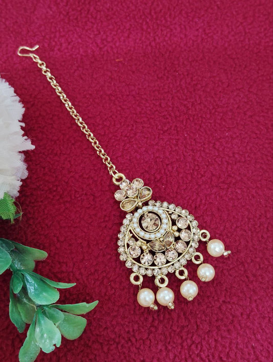 Beautiful gold color tikka with pearls and stones