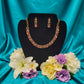 Gold plated fancy necklace set with pink and white stones.