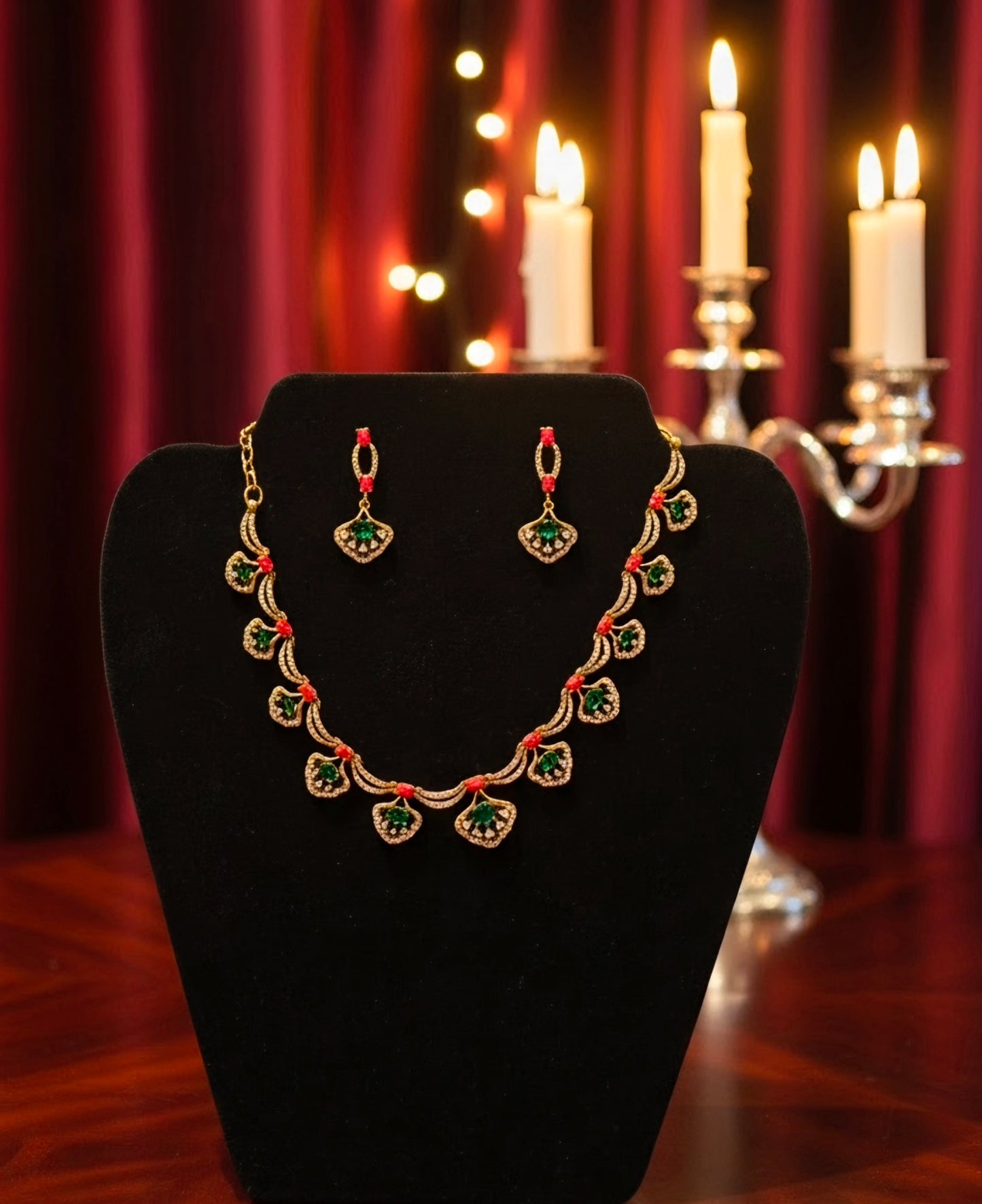 Pretty gold plated curved necklace set with green, red and white stones.