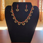 Pretty gold plated curved necklace set with green, red and white stones.