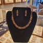 Gold plated fancy necklace set with pink and white stones.