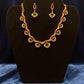 Pretty gold plated curved necklace set with green, red and white stones.