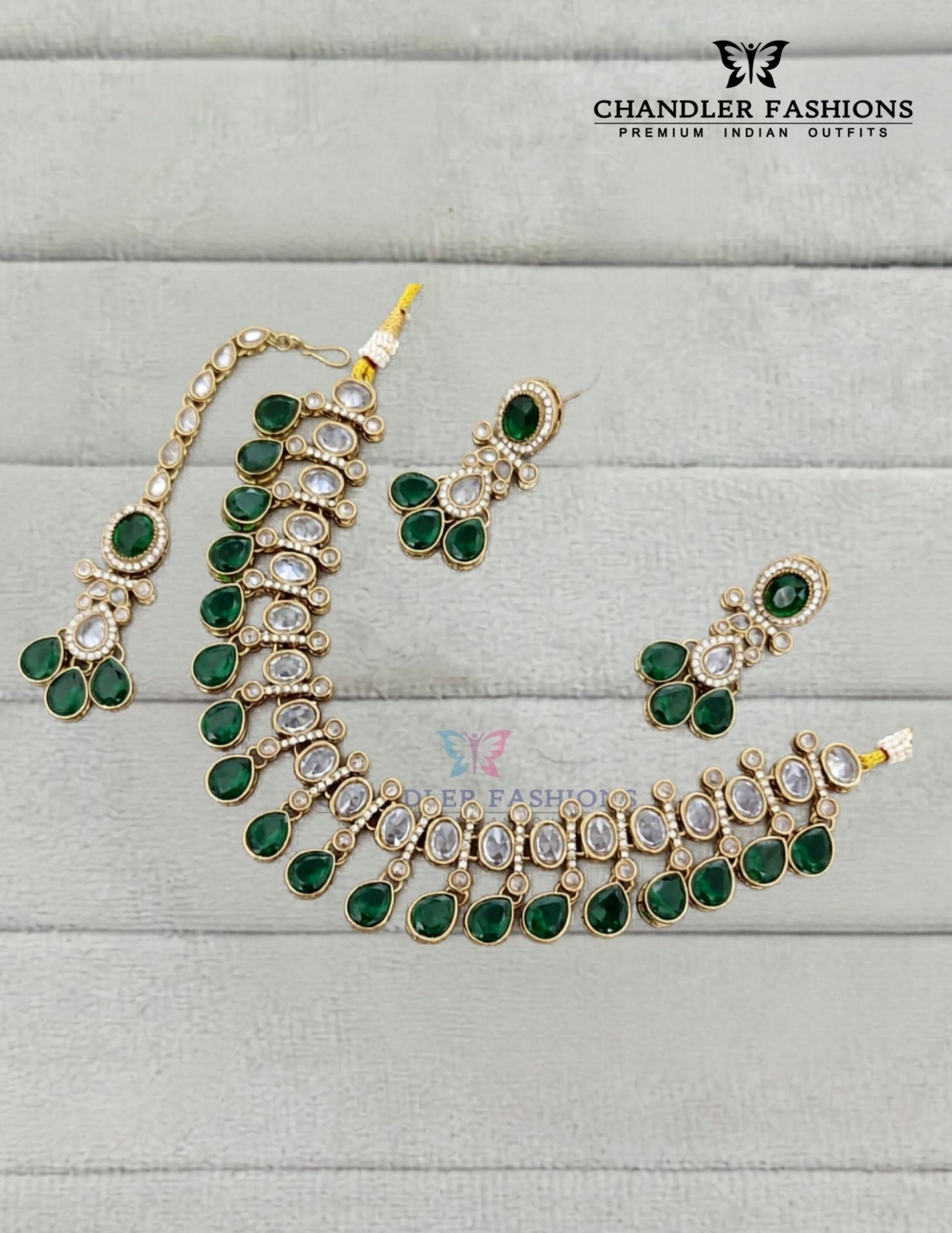 Graceful Gold Plated Dark Green Color Kundan Necklace With Earrings And Maang Tikka