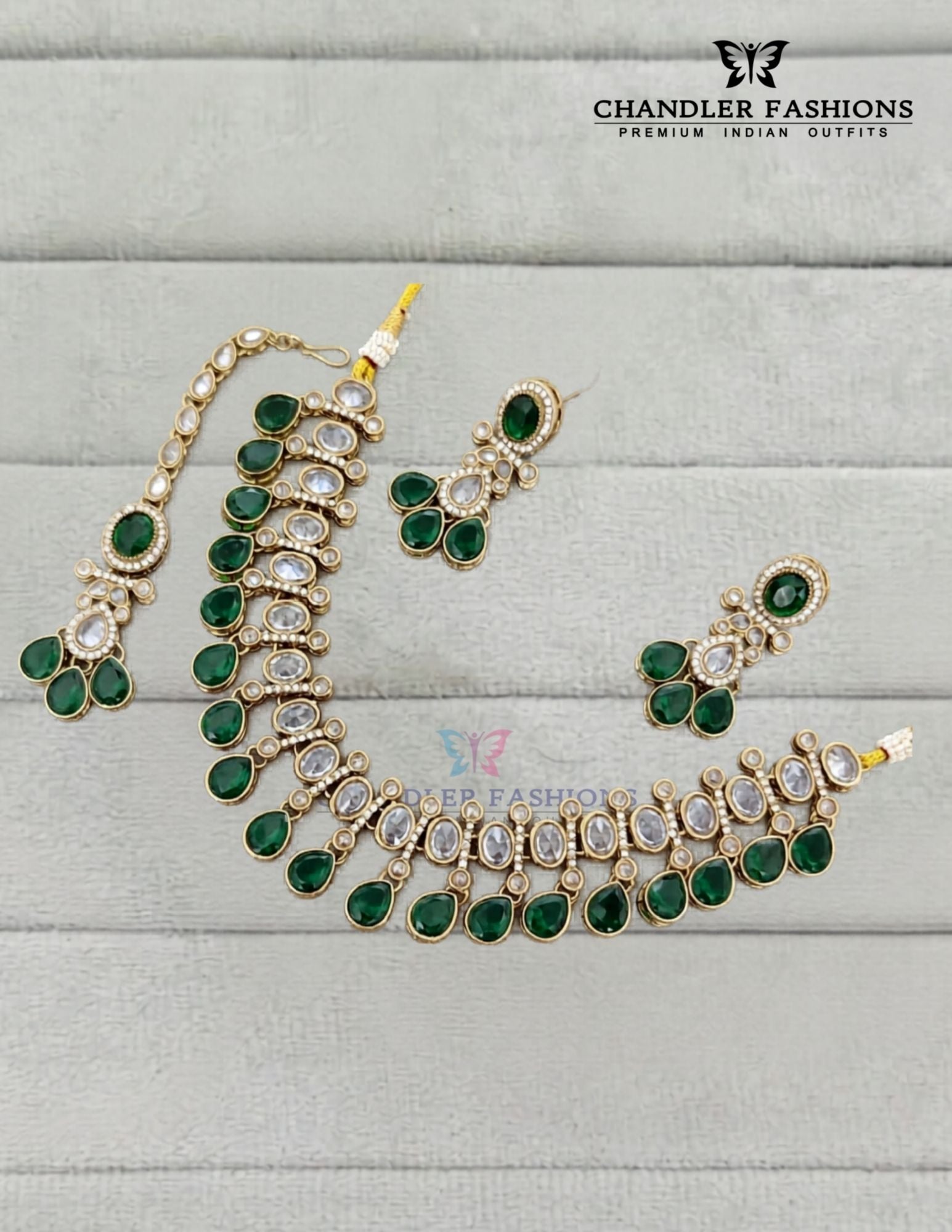 Graceful Gold Plated Dark Green Color Kundan Necklace With Earrings And Maang Tikka
