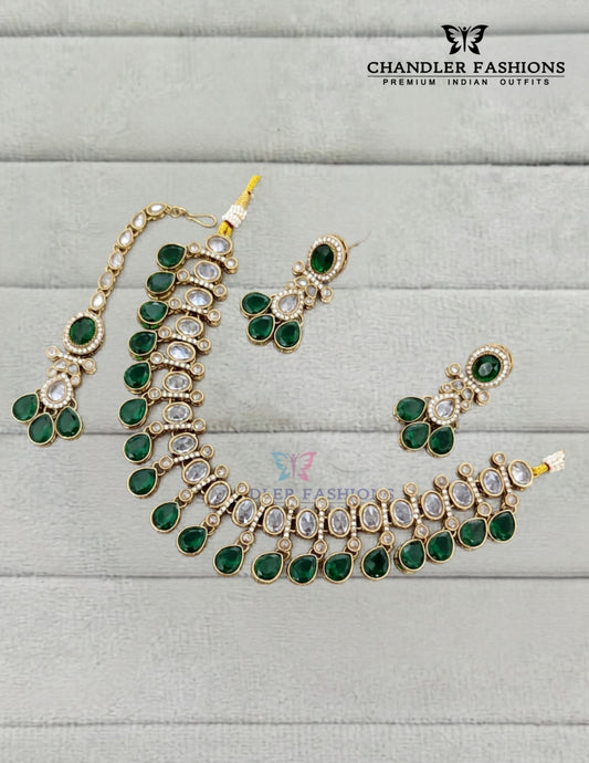 Graceful Gold Plated Dark Green Color Kundan Necklace With Earrings And Maang Tikka