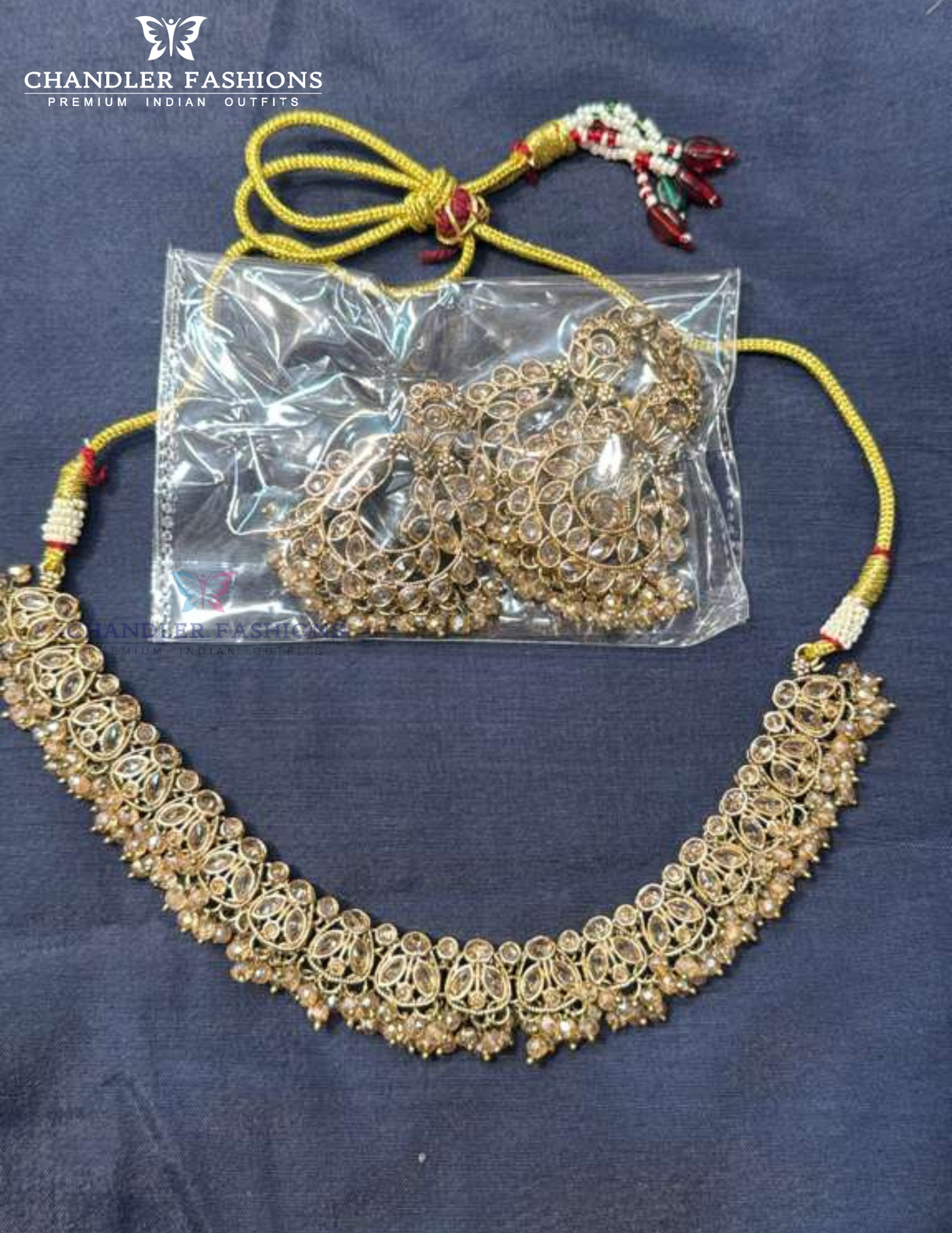 Alluring Gold Color Beads And Gold Stones Necklace With Earrings And Maang Tikka